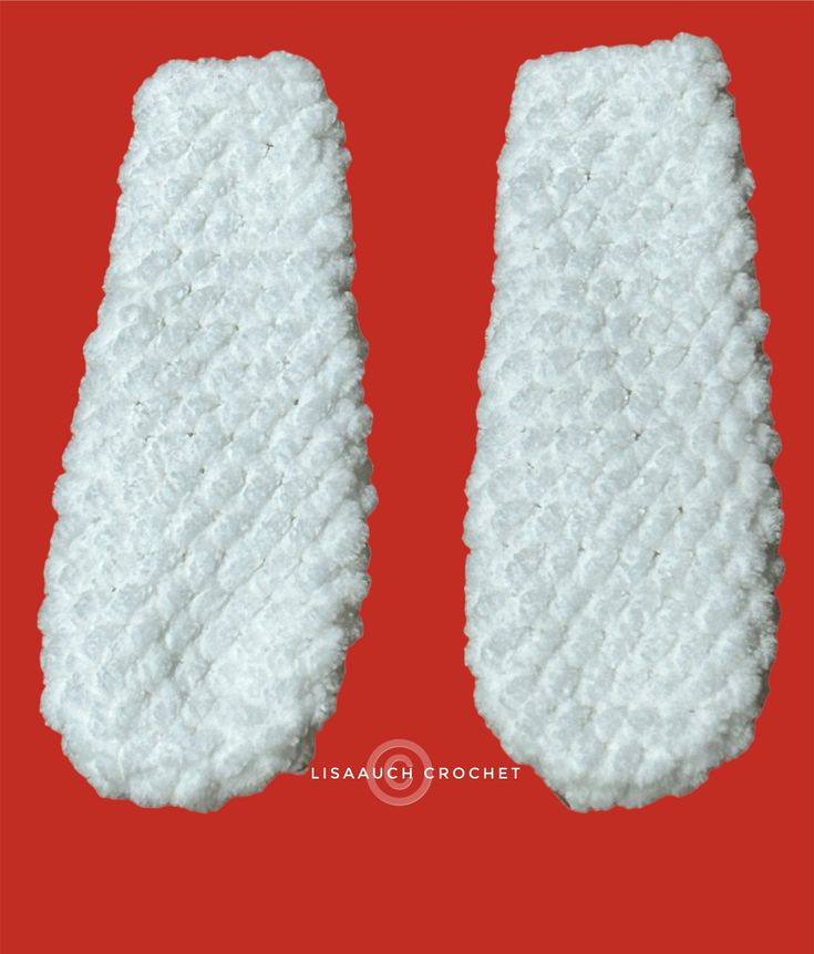 two pieces of white material on a red background