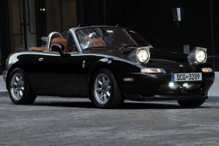 a black sports car parked in front of a building