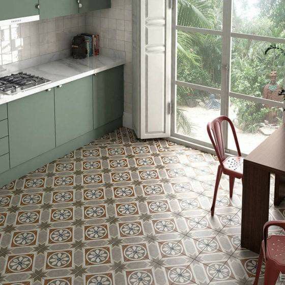 a kitchen with green cabinets and tile flooring next to a table in front of a window