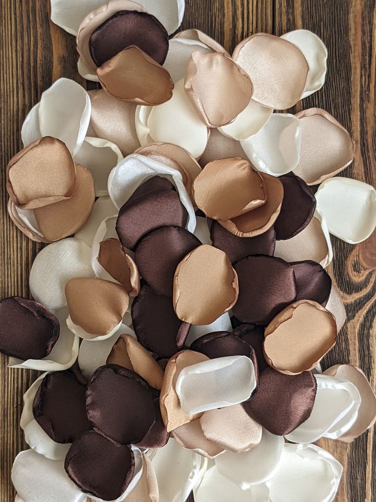 some brown and white flowers on a wooden table