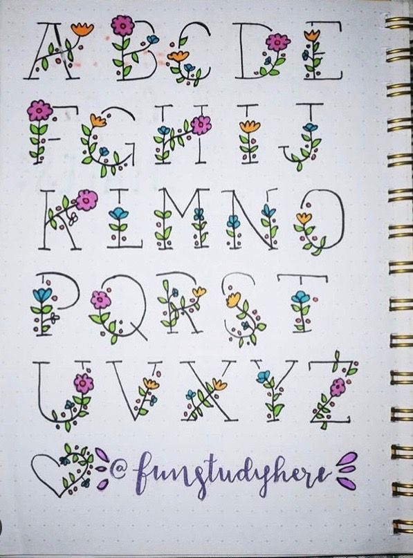 an open notebook with flowers and letters on the pages, all written in cursive writing