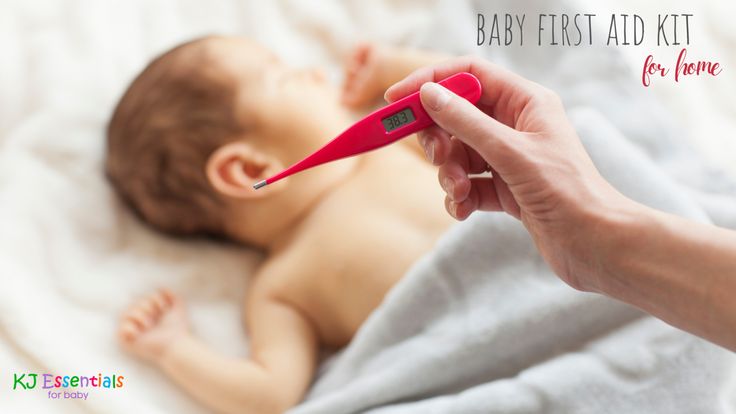 a person is holding a thermometer in front of a baby