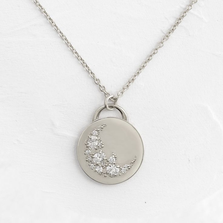 This solid 14k gold pendant is 19.5mm in diameter and 2mm thick. Also available in platinum. It features three oval diamonds (3x4mm) and ten round white diamonds (1-2mm). All accent diamonds are SI clarity and G+ color. The pendant is available on its own or with a 20" cable chain that matches your choice of metal: solid 14k gold or platinum. We handcraft each piece with responsibly sourced metals and ethically sourced stones. Silver Diamond Necklace With Oval Pendant, Silver Oval Diamond Necklace With Single Cut Diamonds, Minimalist Sterling Silver Diamond Necklace With Polished Finish, Minimalist Sterling Silver Necklace With Polished Finish, Sterling Silver Brilliant Cut Oval Pendant Diamond Necklace, Sterling Silver Diamond Necklace With Brilliant Cut Oval Pendant, Luxury Silver Diamond Necklace With Oval Pendant, Oval Link Necklace With Diamond Accents For Gift, Oval Sterling Silver Diamond Necklace With Accents