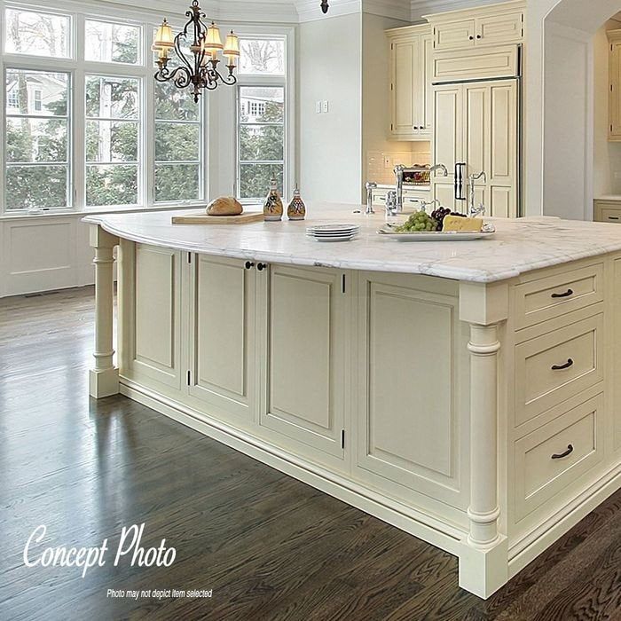 a large kitchen with white cabinets and an island in front of the stove top oven