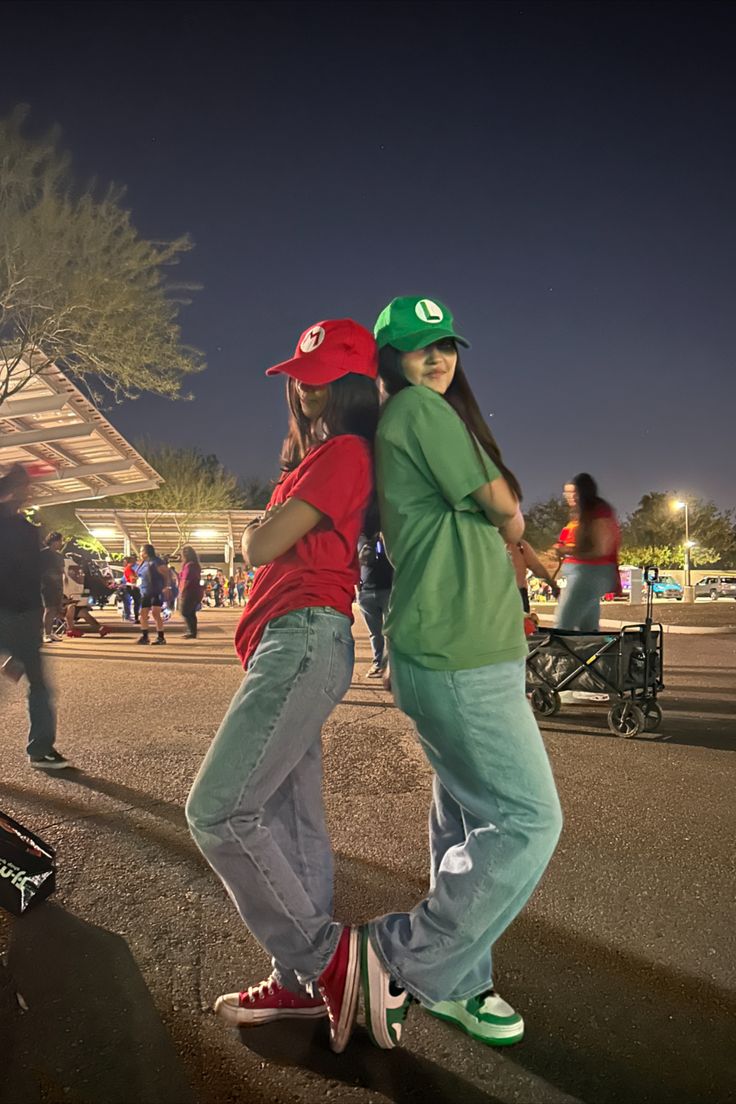 two young people are standing on skateboards in the street, one is hugging the other