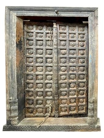 an old wooden door with carvings on it