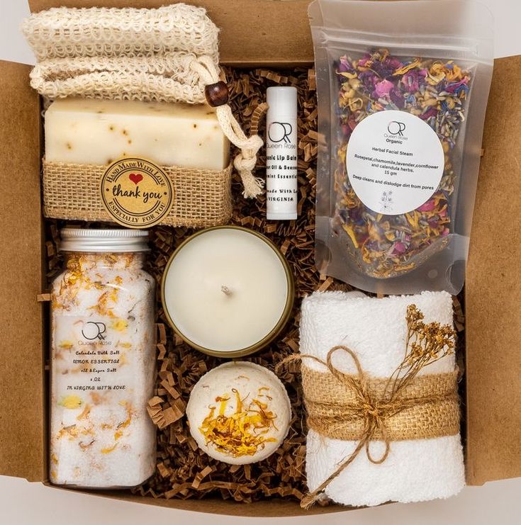 an open box containing candles, soaps and other items