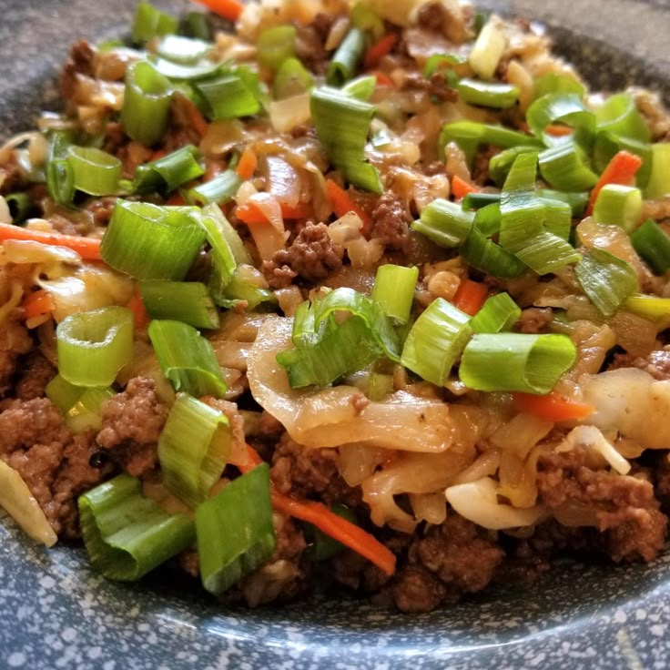 a close up of a plate of food with meat and veggies on it