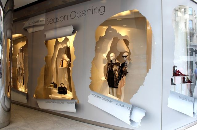 an image of a store window display with mannequins in the front and behind it