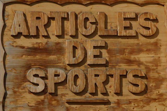 a wooden sign that says articles de sports