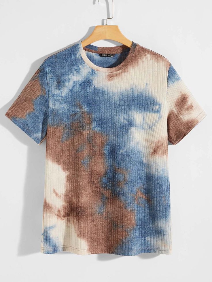 a blue and brown tie dye t - shirt hanging on a hanger