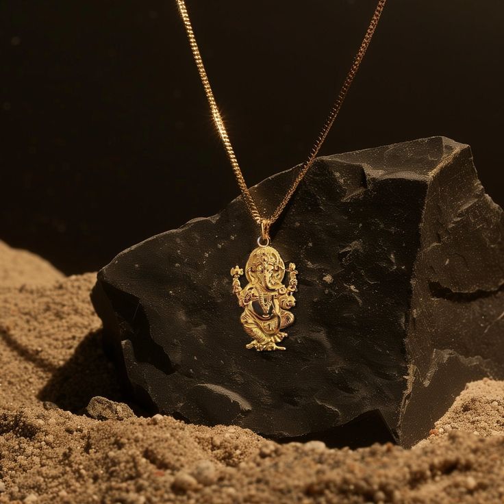 Elevate your spirit with our gold Ganesh pendant. Crafted in solid gold, this necklace beautifully captures the essence of the revered figure known for wisdom and prosperity. More than just an accessory, this pendant serves as a timeless symbol that resonates with those appreciating cultural heritage and meaningful connections. PENDANT INFORMATIONThis pendant is made of real, solid gold.• Made in USA• Material: 14k or 18k solid gold• Finish: polished• Height: 1.32" (33,5 mm) x Width: 0.8" (20 mm)• Pendant weight: approx. 6 grams (14k)• Bail: fits up to 4 mm chains• Solid back, not hollow• A certificate of authenticity is included• Delivered in our elegant jewelry box, making it the perfect gift Shipping: All of our orders are custom-made. Please allow approximately 3 weeks for production a Gold Pendant Jewelry For Navratri, 22k Gold Locket Jewelry For Rituals, Gold Spiritual Jewelry For Festive Season, Spiritual Yellow Gold Festive Jewelry, Spiritual Gold Jewelry For Festive Occasions, Spiritual Gold Jewelry For Festive Season, Festive Gold Spiritual Jewelry, Yellow Gold Jewelry For Navratri Rituals, Gold Plated Locket For Puja