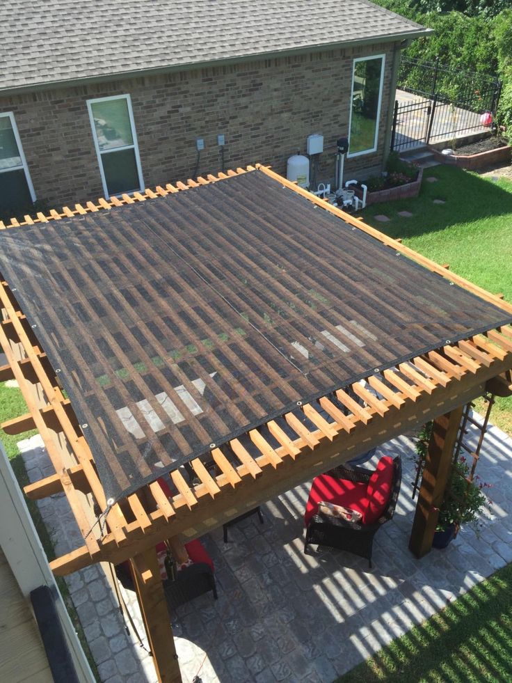 an overhead view of a patio with a pergolated cover on the top floor