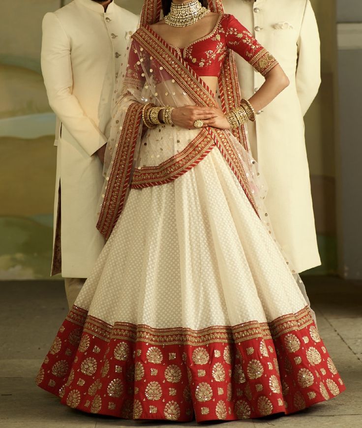 a man and woman standing next to each other in formal attire, posing for the camera