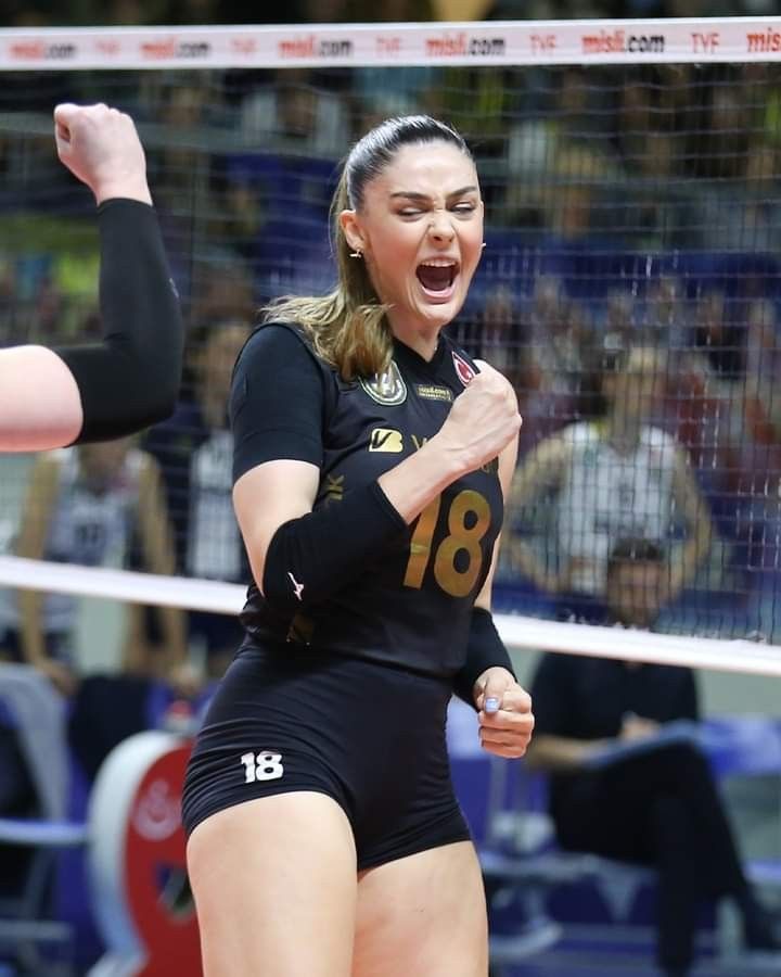 a female volleyball player celebrates her victory over the net