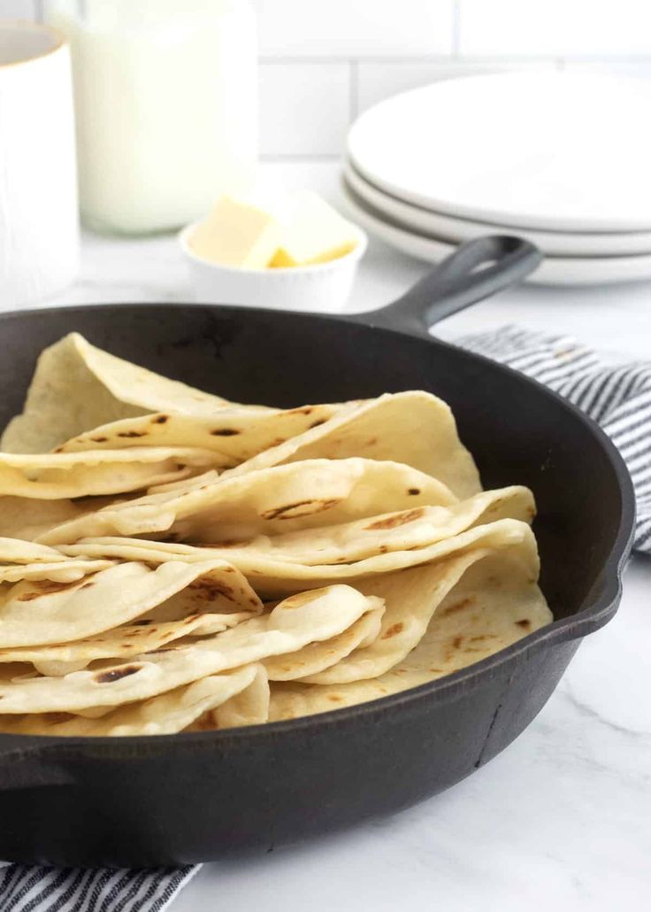 tortillas in a cast iron skillet ready to be cooked