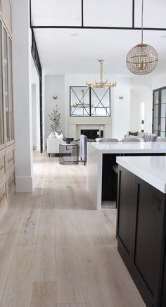 an open floor plan with white walls and wood floors