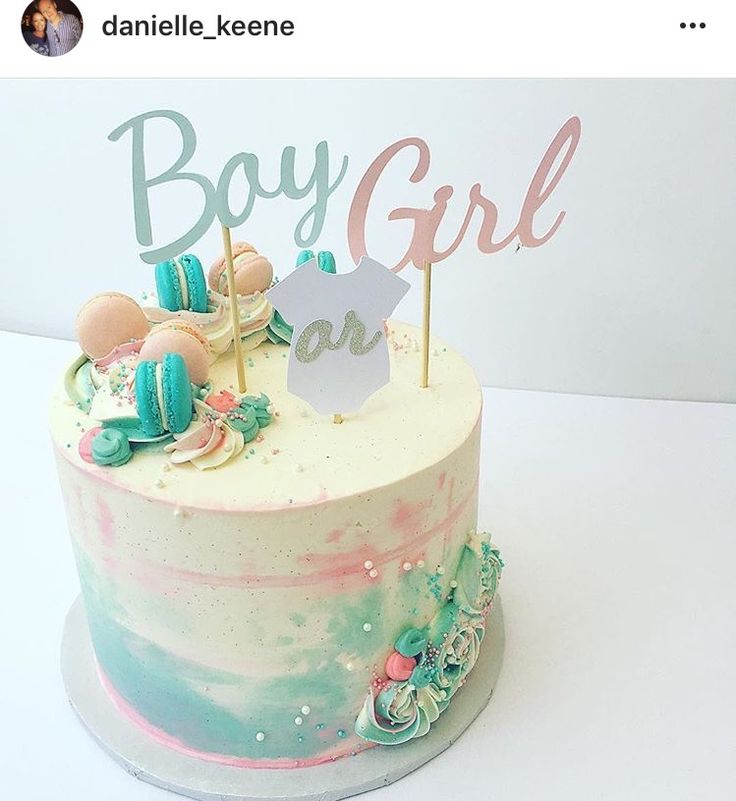 there is a cake that has been decorated with pastel colors and the words boy girl are on top