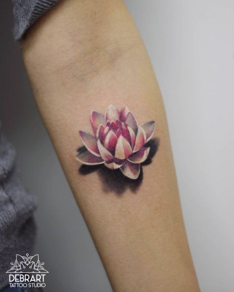 a pink flower tattoo on the arm