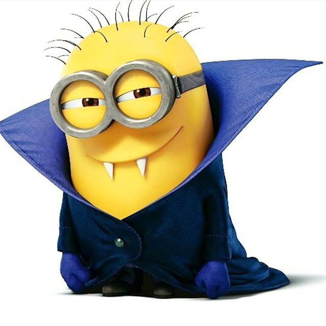 a minion with glasses and a cape on sitting in front of a white background