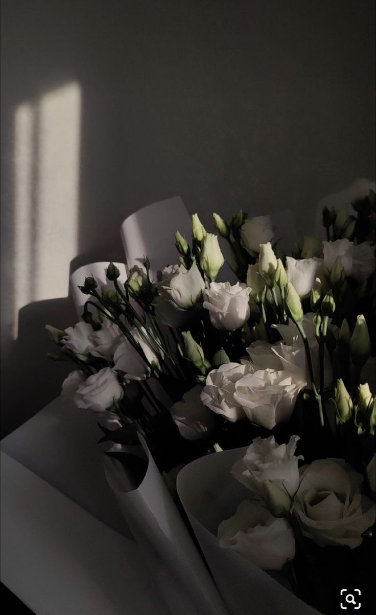 a bouquet of white flowers sitting on top of a table