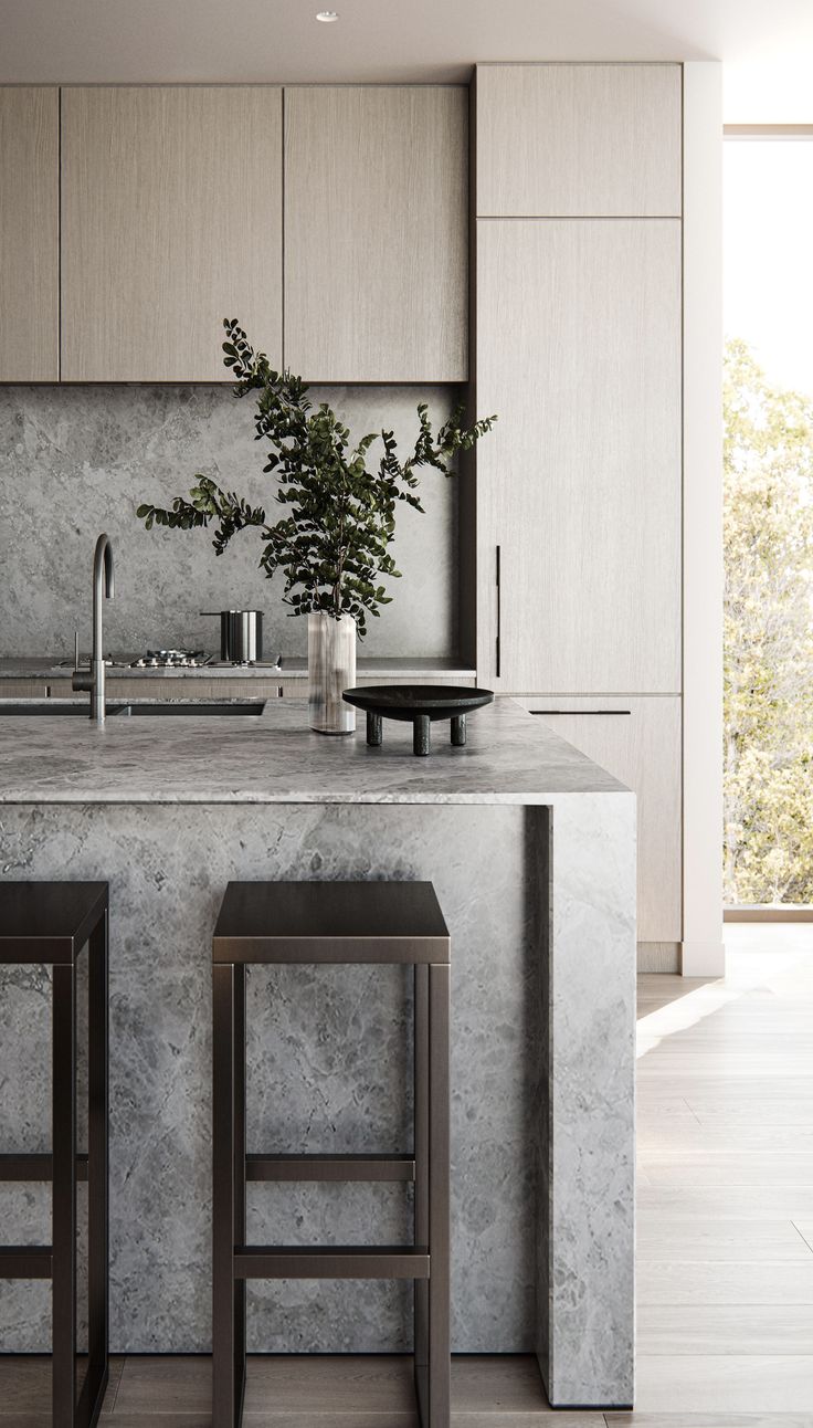 two stools are in front of the kitchen counter and bar with plants on it