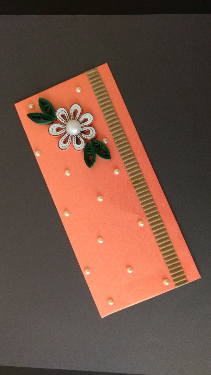 an orange card with a flower on it