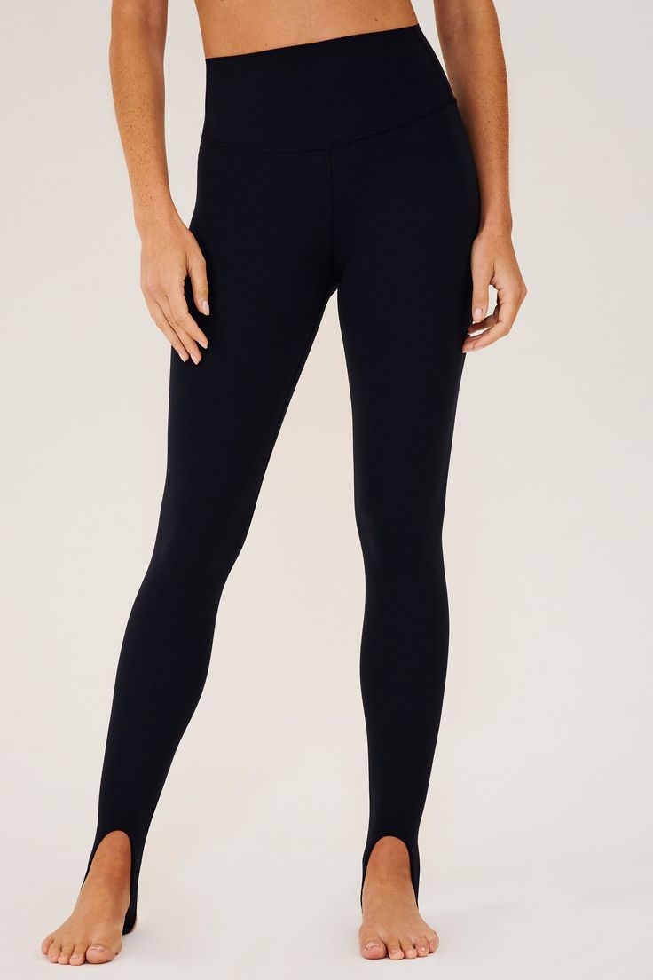 Our famous, form fitting high waist legging redesigned as a stirrup tight. Our ultra luxe Airweight fabric has a supremely soft hand and second skin comfort. BEST FOR: hot yoga, barre, Pilates. Model is 5'10" and wears a size small. Sleek Compressive Leggings For Pilates, Sleek Yoga Tights, Sleek Compression Yoga Bottoms, Sleek Full-length Workout Leggings, Sleek Yoga Leggings With 4-way Stretch, Sleek Leggings With 4-way Stretch For Yoga, Sleek 4-way Stretch Yoga Leggings, Sleek 4-way Stretch Leggings For Yoga, Fitted Black Bottoms For Barre