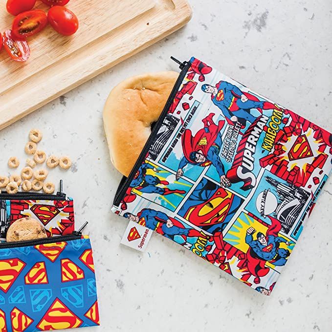 the lunch bag has superman comic print on it and is next to some other items