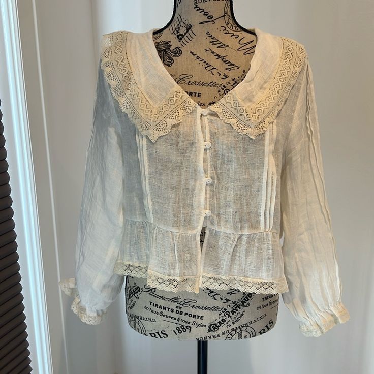 Zara Linen Blend Blouse With Long Sleeves Loose Fit Size Us Xs Unique Style As Purchased Overseas Beautiful Detail Runs Down Length Of Sleeve And Front Of Blouse Lace Edging On Collar, Cuffs And Bottom Of Blouse Vintage / Boho Appearance Off-White / Ivory Cotton Vacation Blouse With Collar, Cotton Blouse For Vacation, Spring Cottagecore Lace Top, Feminine Linen V-neck Blouse, Spring Vacation Blouse With Collar, Long Sleeve Top With Lace Collar For Summer, Feminine Linen Blouse For Vacation, Daywear V-neck Blouse With Lace Collar, Cottagecore Blouse For Daywear