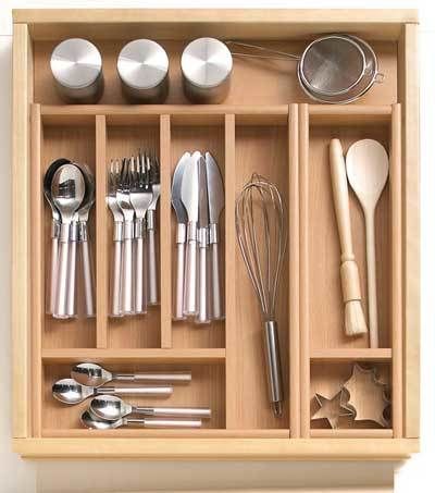 a wooden drawer with utensils and spoons in it