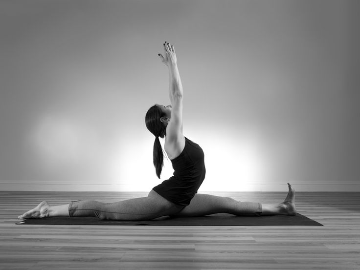 a woman is doing yoga on the floor