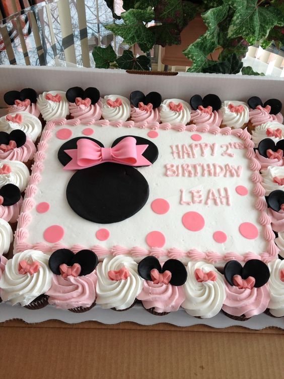 a minnie mouse birthday cake with pink and white frosting