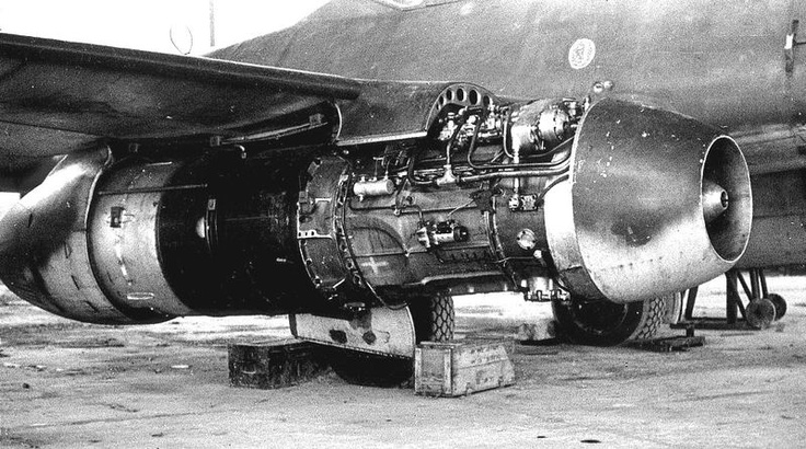 an old jet engine sitting on top of a tarmac