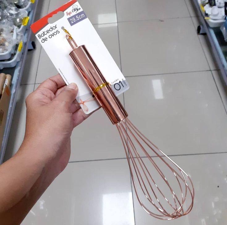 a person holding a whisk in their hand