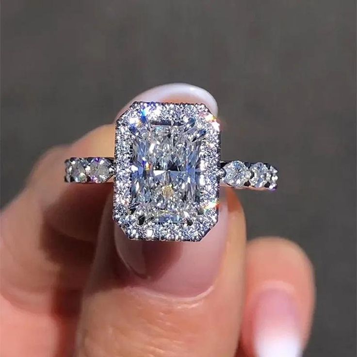 X✥ S T O N E S ↣ Shape : Radiant Cut Moissanite ↣ Color : Colorless ↣ Clarity : VVS ↣ Size : 3.00 CT ↣ Measurement : 9X7 MM ↣ Luster : Excellent ↣ Make : High Quality ✥ S I D E S T O N E S ↣ Shape : Round & Marquise Cut Moissanite ↣ Color : Colorless ↣ Clarity : VVS ↣ Size : 1.00 TCW ↣ Luster : Excellent ↣ Make : High Quality ✥ M A T E R I A L S ↣ Made In Solid 925 Sterling Silver ↣ 10K Gold, 14K Gold, 18K Gold, Platinum ↣ 925 Sterling Silver White/Yellow/Rose Gold Plated ↣ Solid White/Yellow/Ro Rectangular Engagement Ring, Halo Radiant Cut Engagement Ring, Radiant Halo Ring, Engagement Ring Radiant Cut, Engagement Ring With Halo, Radiant Cut Ring, Engagement Ring Radiant, Gold Ring With Diamond, Radiant Cut Moissanite Engagement Ring