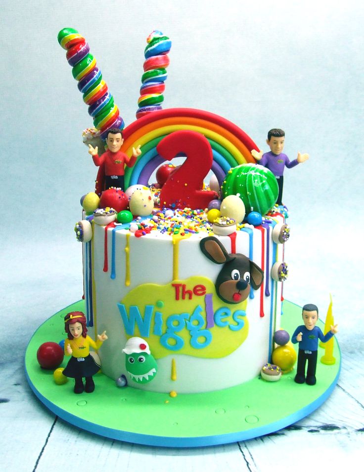 a birthday cake decorated with toys and decorations