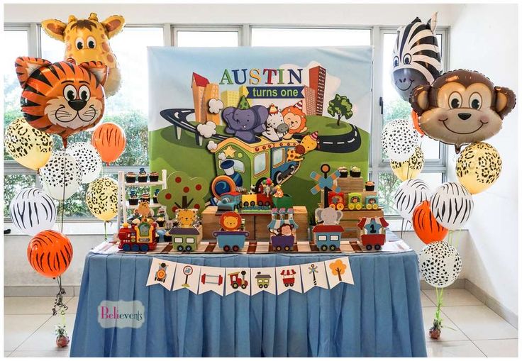 an animal themed birthday party with balloons and decorations