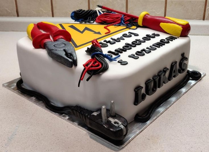 a cake that is decorated to look like a construction site with tools on it and the word work written in large letters