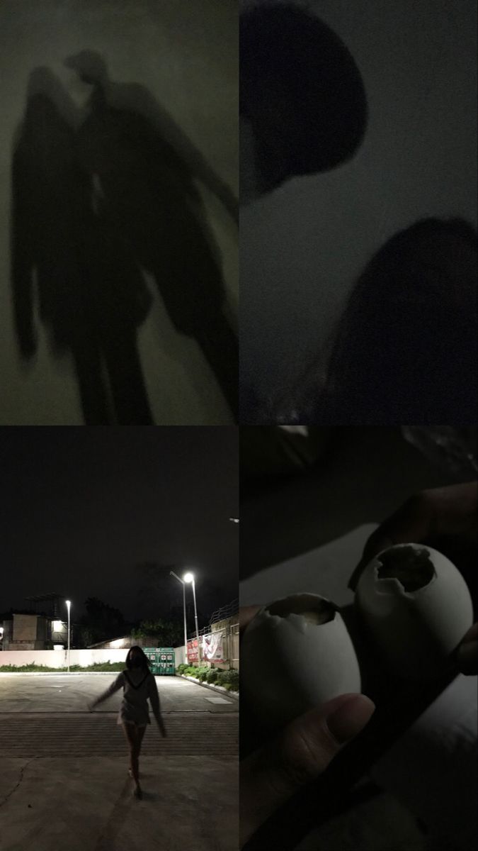 the shadow of two people walking in front of a building at night, and one person holding an object with their hand