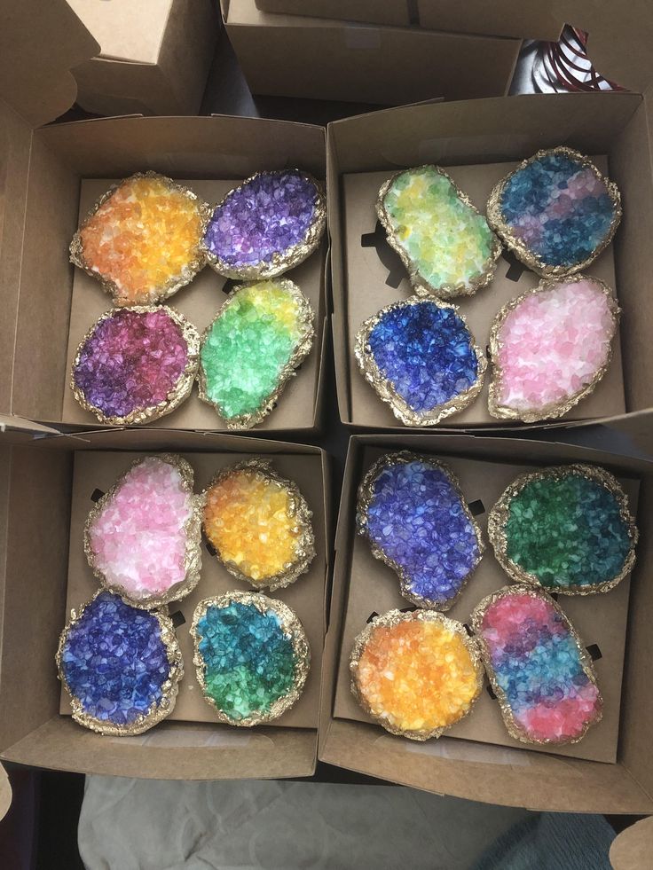 four boxes filled with different colored candies in them