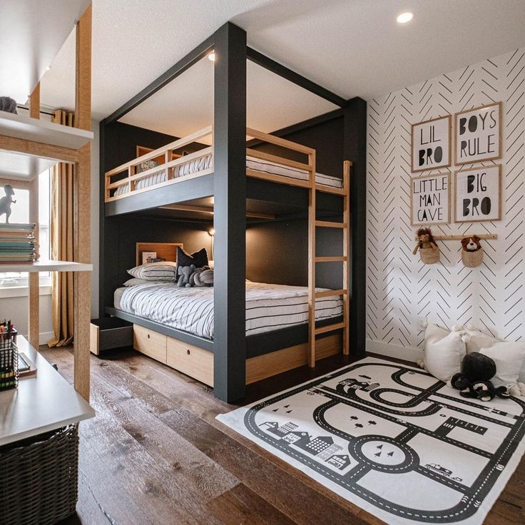 a bedroom with bunk beds and a rug on the floor in front of it that is decorated with black and white wallpaper