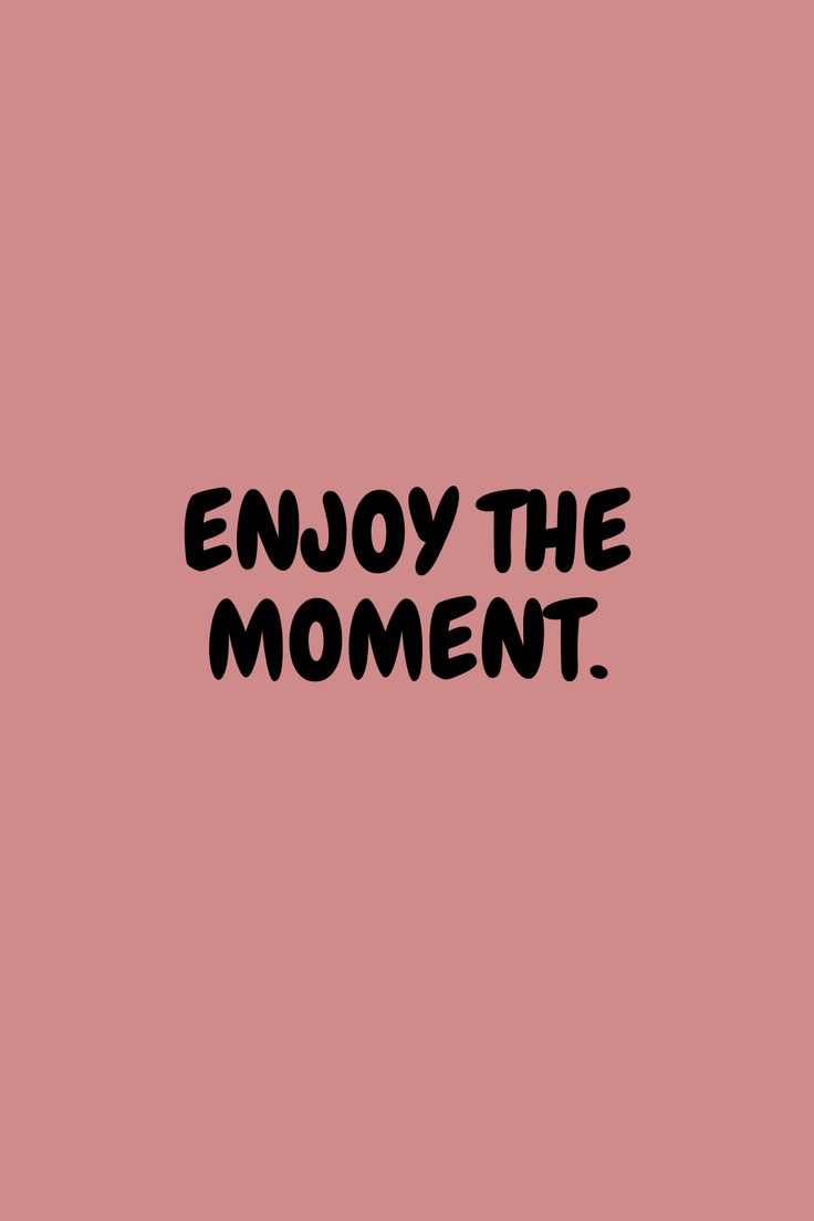 the words enjoy the moment written in black ink on a pink background with an image of a