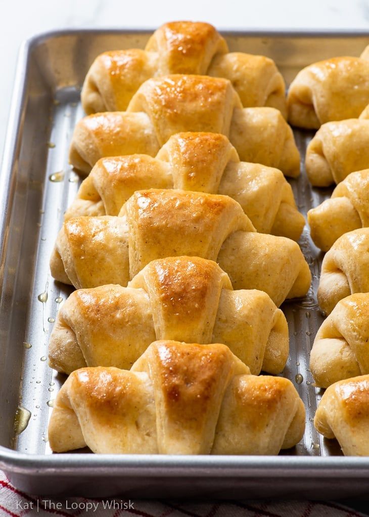 freshly baked pastries on a baking sheet ready to be cooked in the oven,