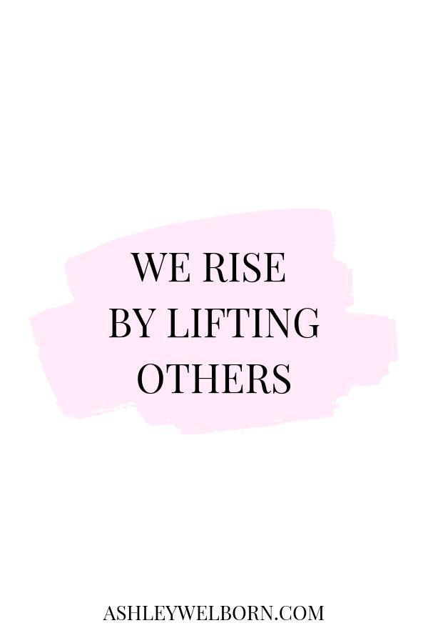 the words, we rise by lifting others in black and white on a pink background