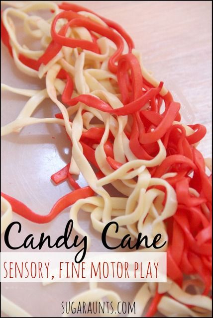 red and white candy canes on a plate with the words candy cane sensory, fine motor play