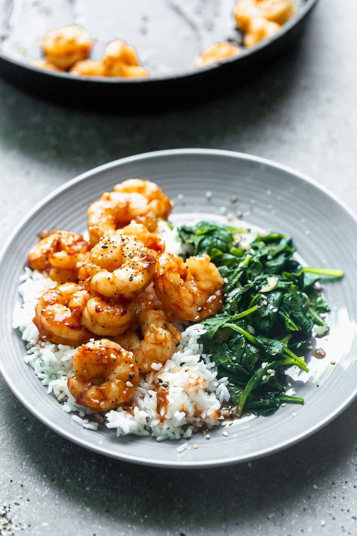 shrimp and spinach served with rice on a plate