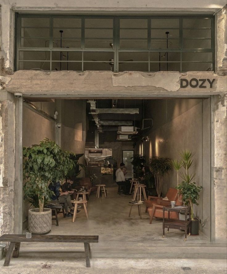 an open door to a restaurant with people sitting at tables and chairs in front of it