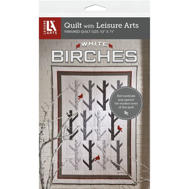 the white birch tree quilt kit is shown in front of a brick wall with red birds on it