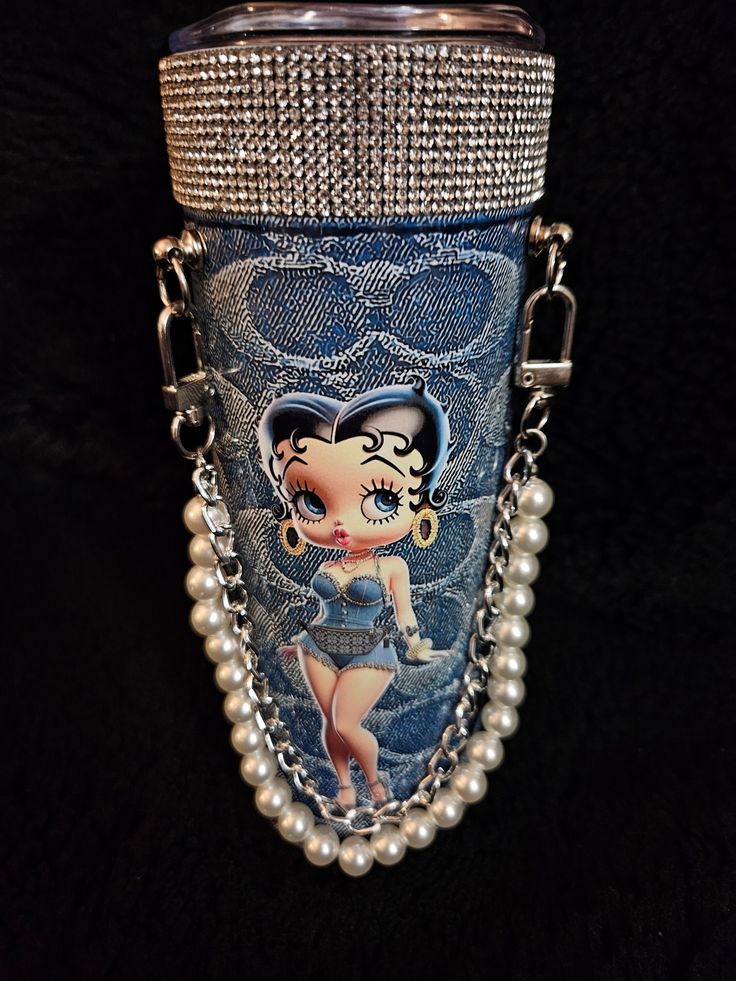 a close up of a cell phone case with a chain attached to it and a cartoon character on the back